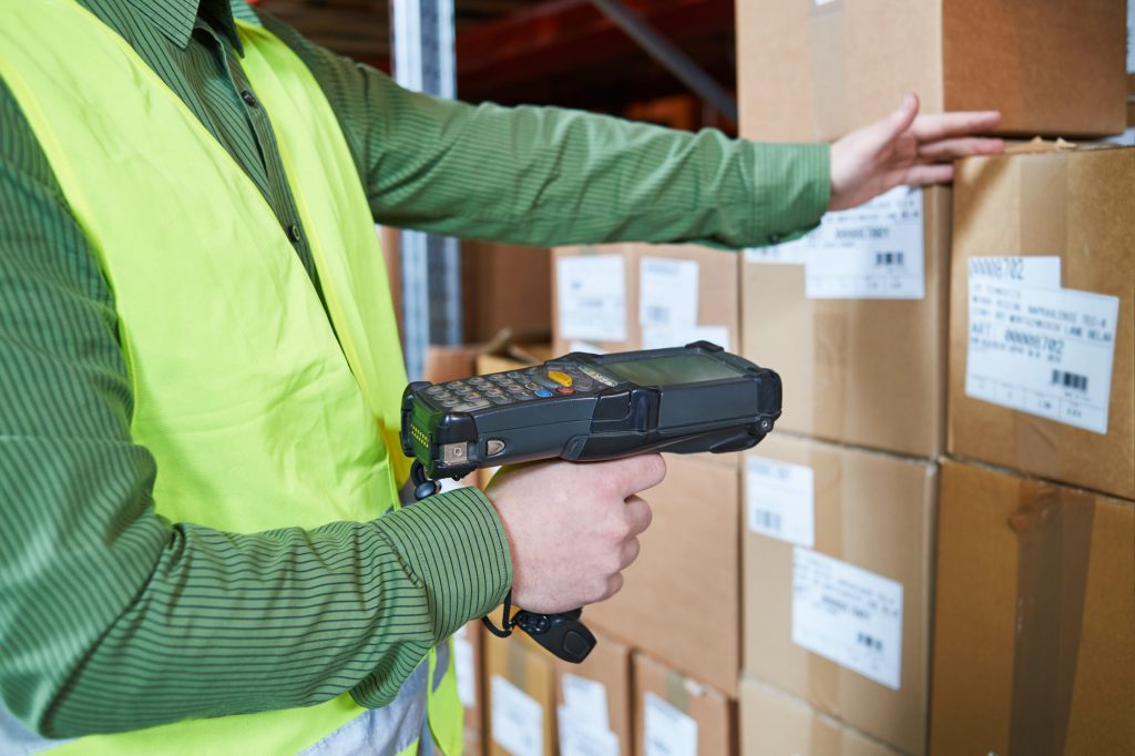 Warehouse Management System. Worker with barcode scanner