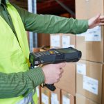 Warehouse Management System. Worker with barcode scanner